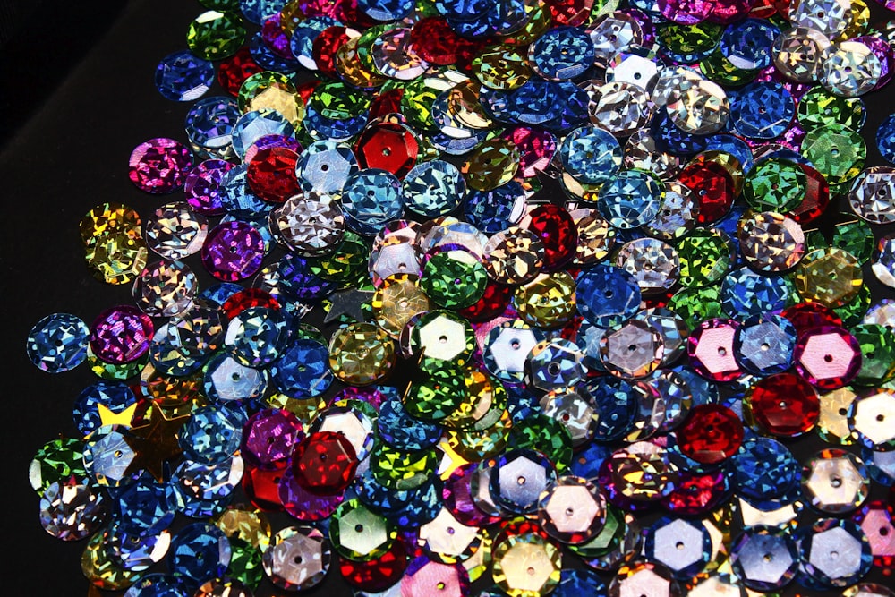 a pile of different colored diamonds on a table