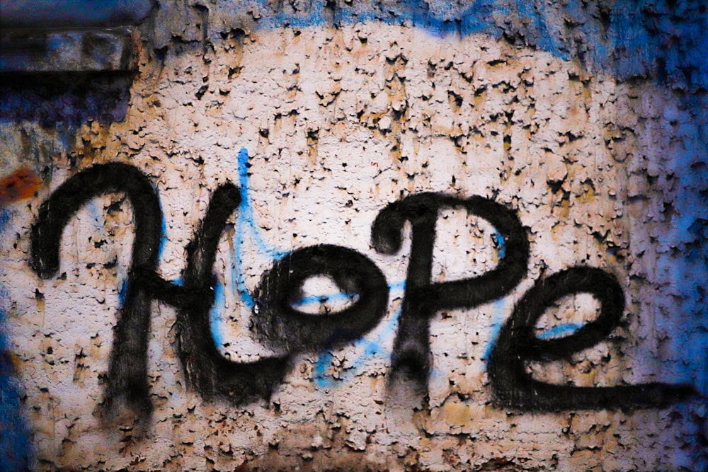 graffiti on the side of a building that says hope