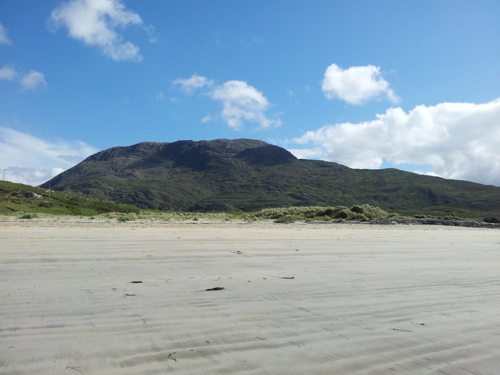 a beach with a mountain in the background