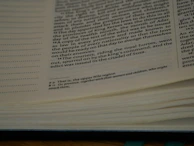 Close-up of a hand flipping through yellowed pages of a classic philosophical book.