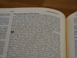 A close-up of an open book focusing on a page with a passage titled 'The triumph of the Jews.' The text discusses Mordecai and a celebration of happiness and joy in a biblical context. The page number 376 is visible, and the header indicates it's from the Old Testament.