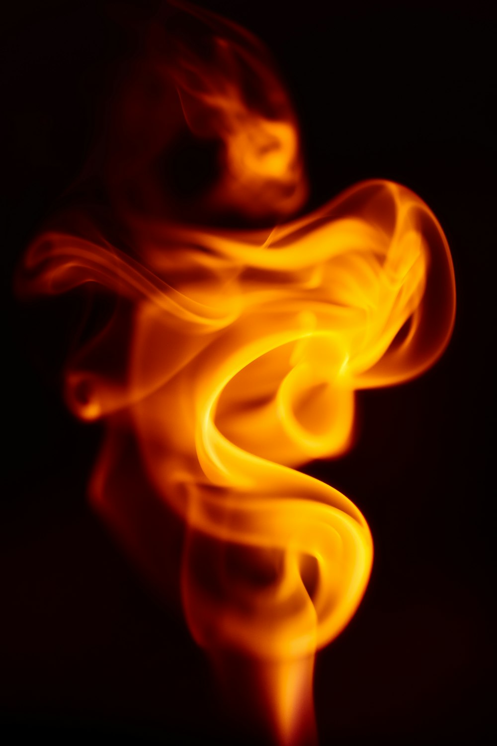 a blurry photo of a fire on a black background