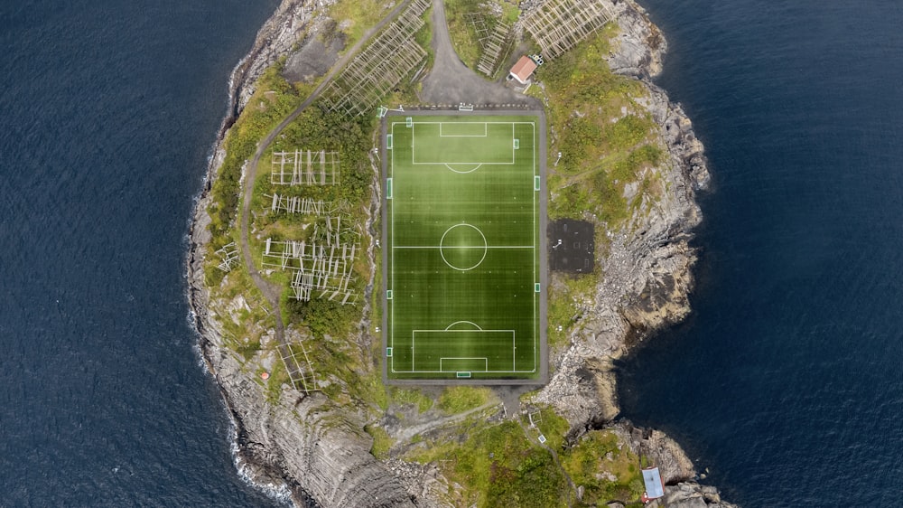 an aerial view of a soccer field on an island