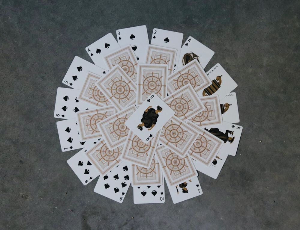 a group of playing cards sitting on top of a floor