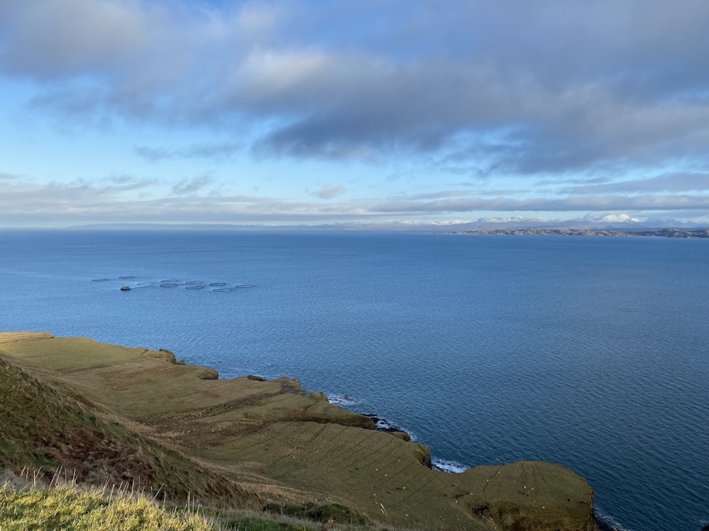 a large body of water sitting on the side of a hill