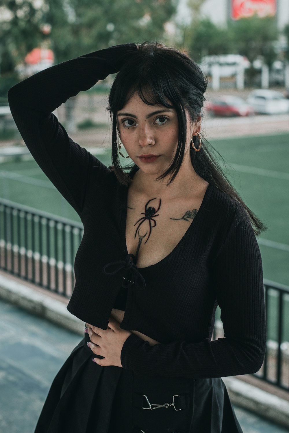 a woman with a spider tattoo on her chest