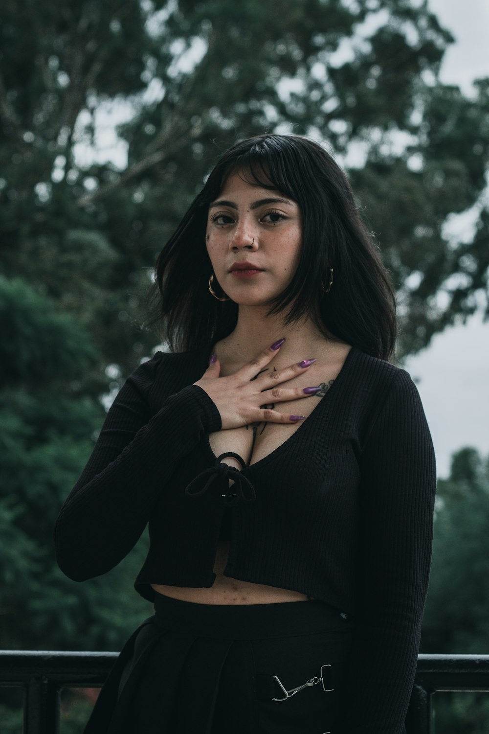 a woman with long black hair wearing a black top