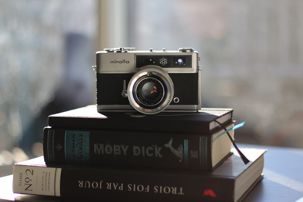 a camera sitting on top of a stack of books