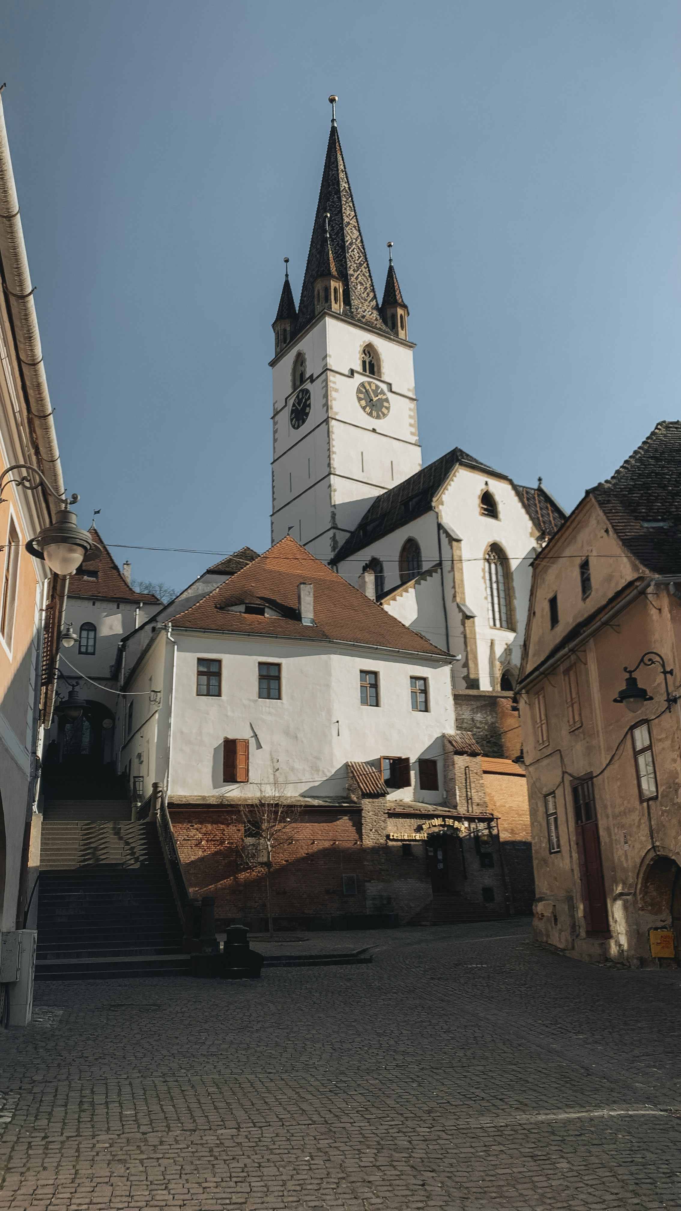 a large white building with a clock tower