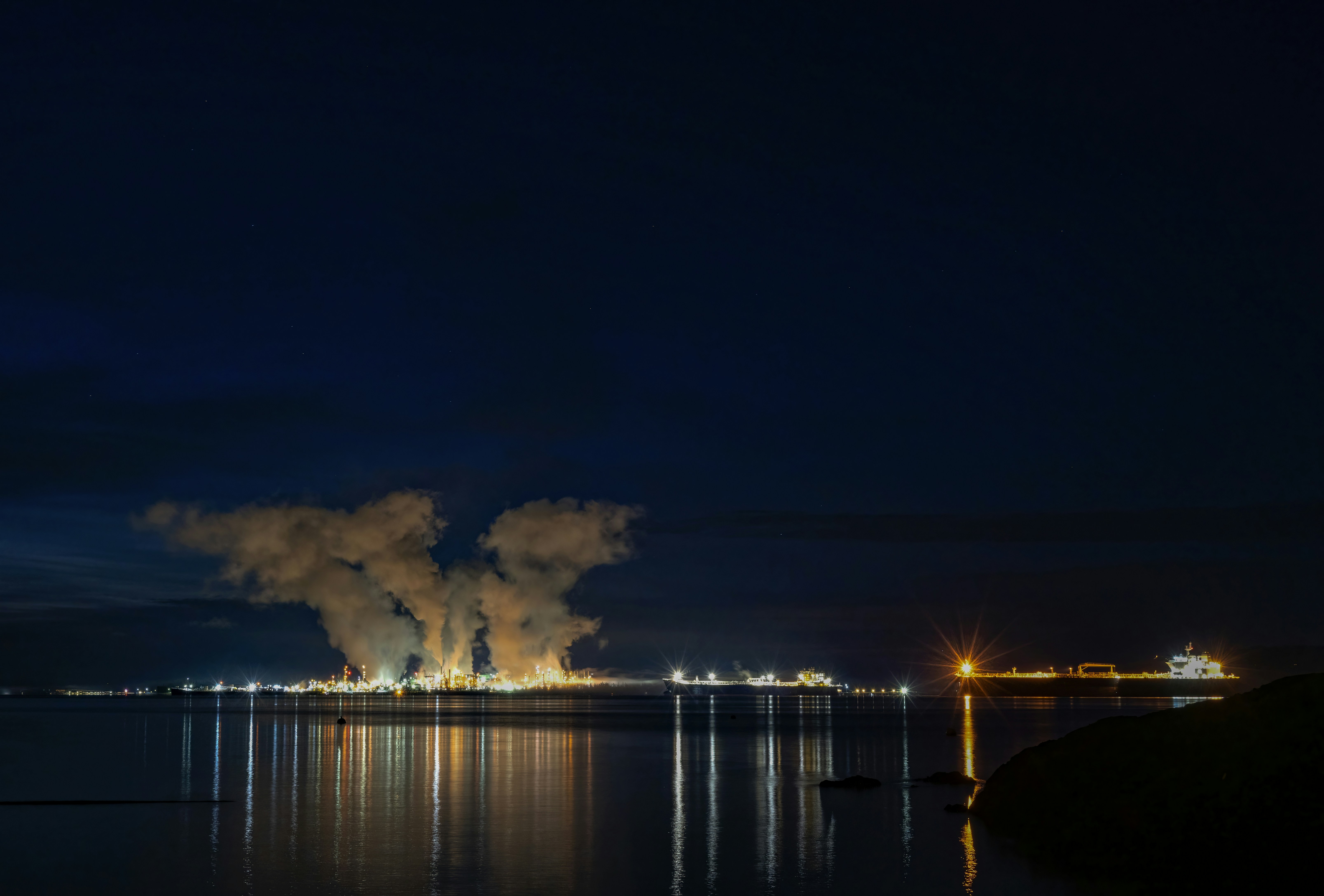 Refinery structure against a clear blue sky.