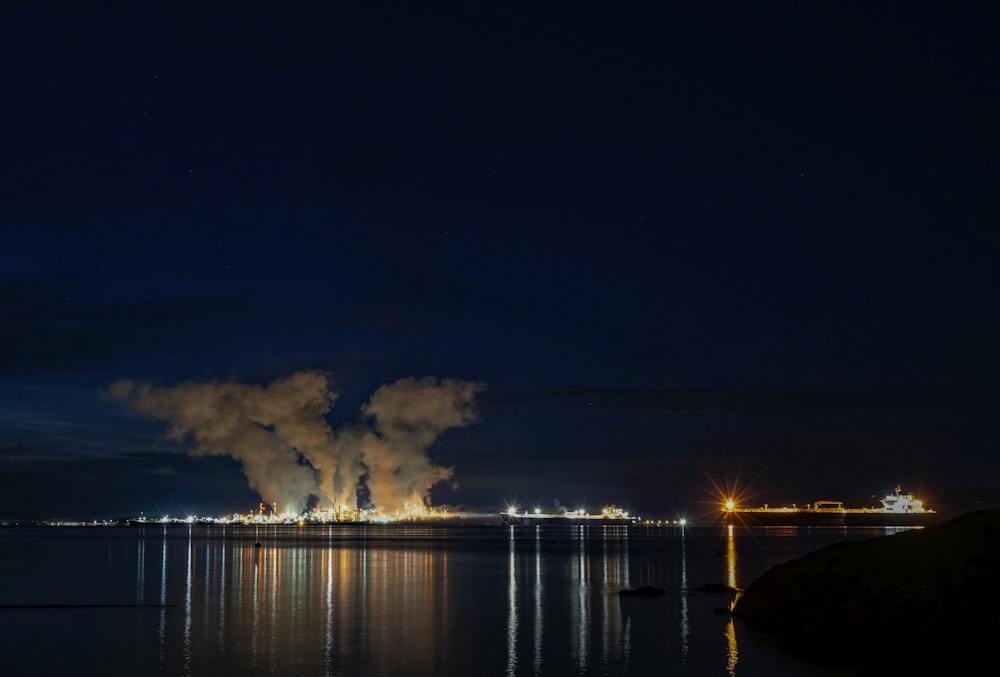 a large industrial plant is lit up at night