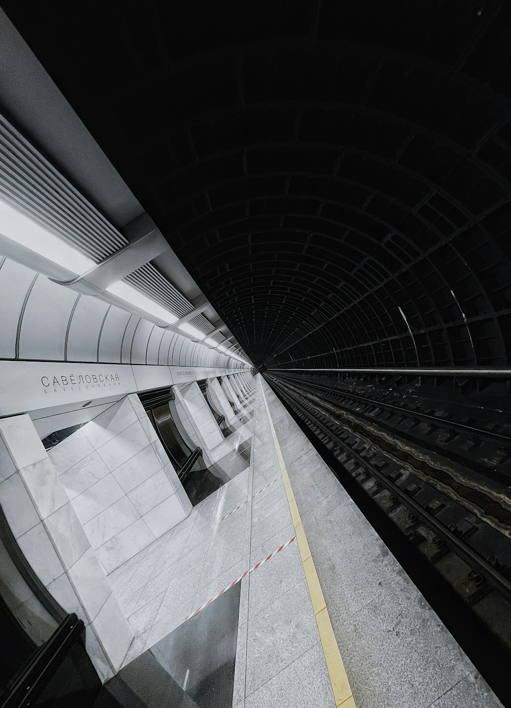 a train traveling through a tunnel next to a platform