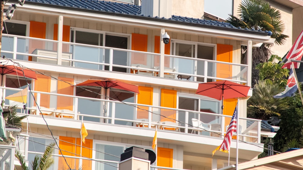 an orange and white building with an american flag flying in front of it