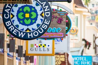 a bunch of signs hanging from the side of a building