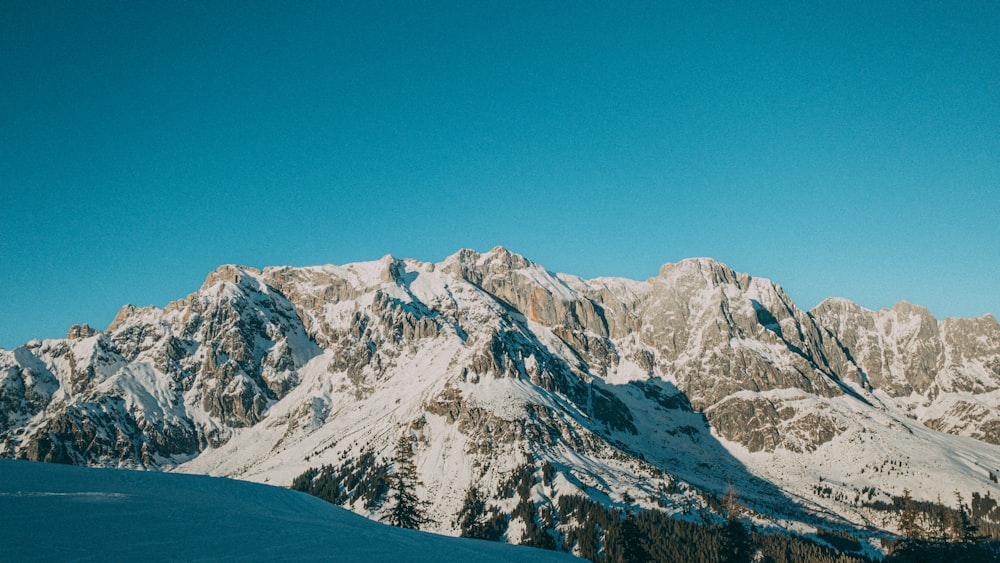 a person riding skis on top of a snow covered slope