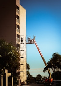 a man on a lift working on a building