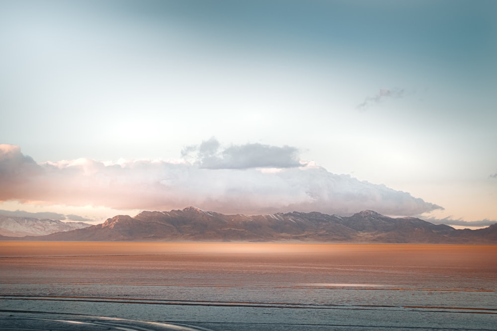 a large body of water sitting under a cloudy sky