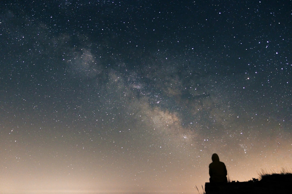 a person looking up at the stars in the sky