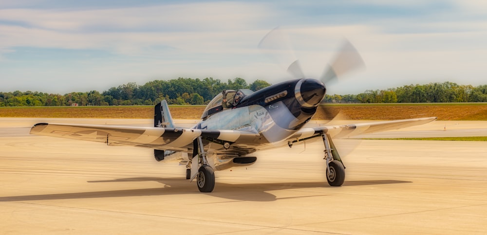 a small airplane sitting on top of an airport tarmac