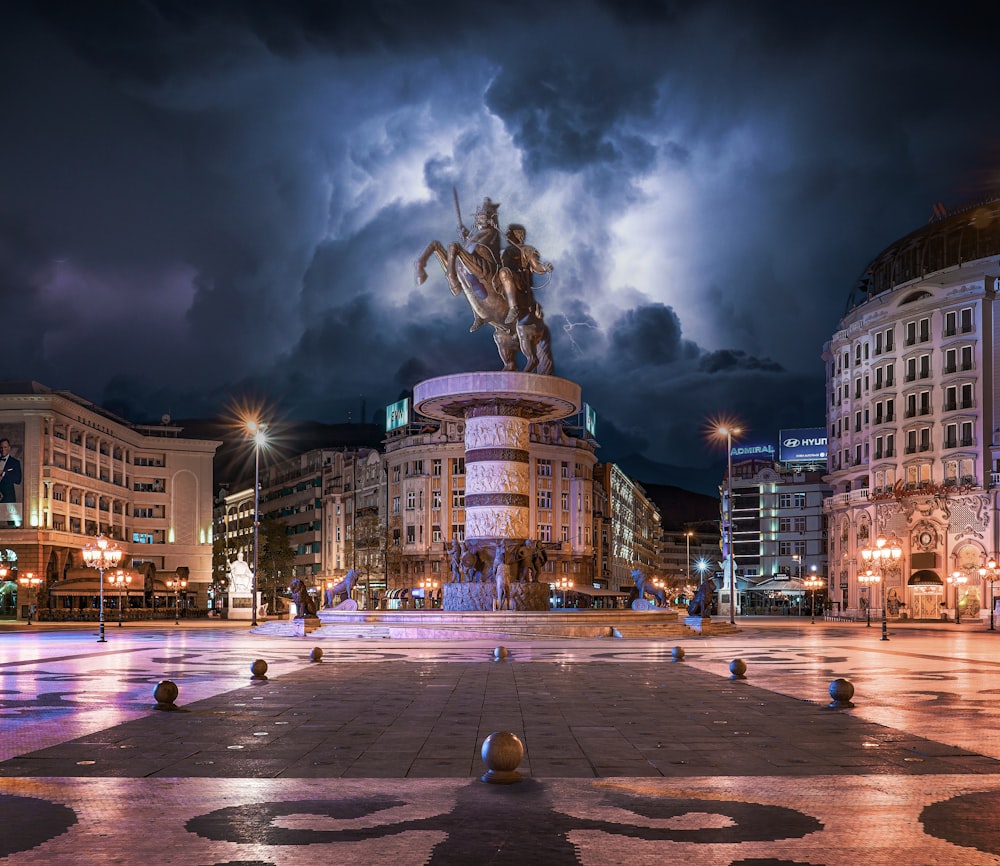 a statue of a man riding a horse in a plaza