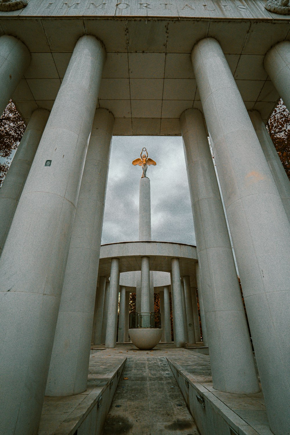 a tall white building with a cross on top of it