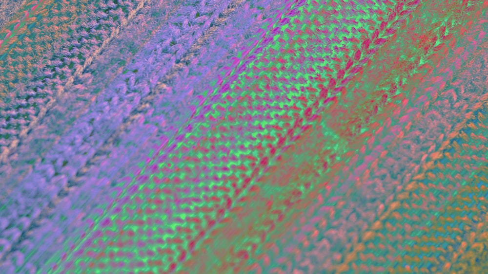 a close up of a knitted material with a multicolored pattern