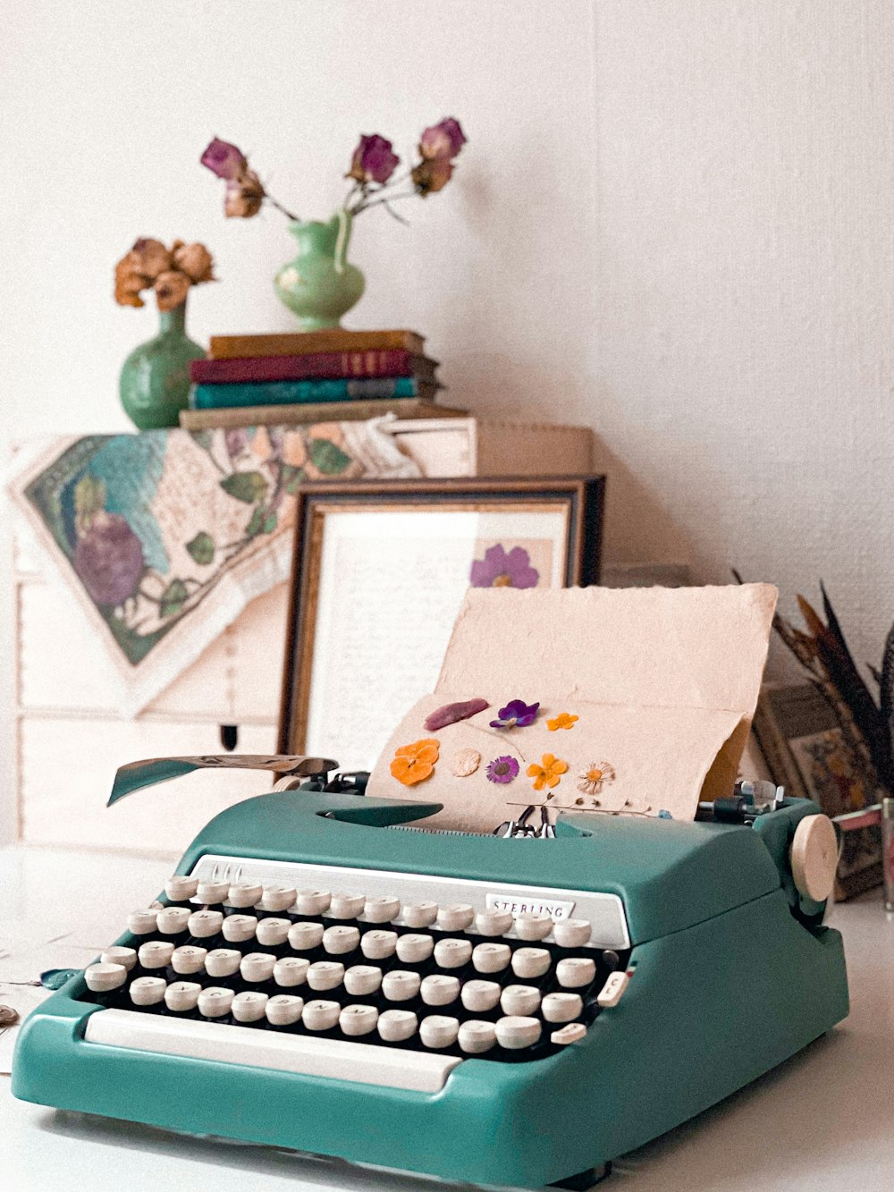 a blue typewriter sitting on top of a white table