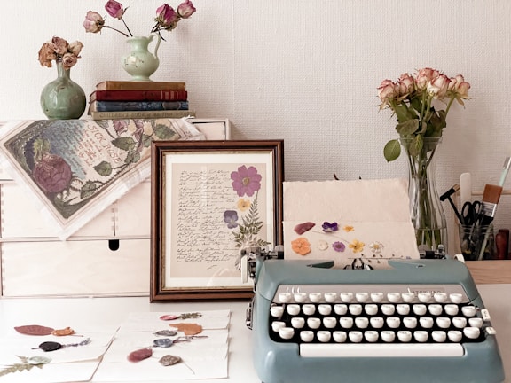 a blue typewriter sitting on top of a white desk