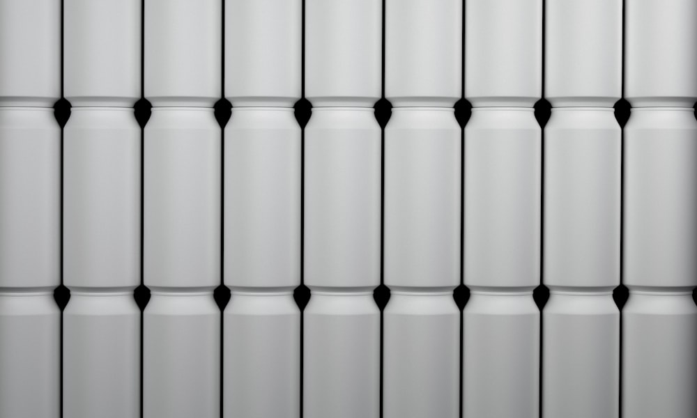 a close up of a white wall with black dots