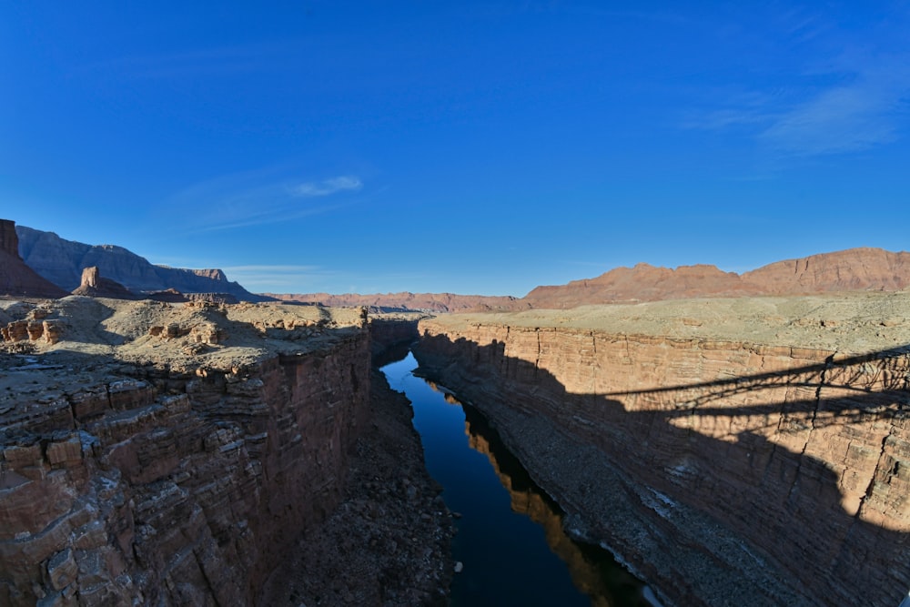 a river running through a canyon surrounded by mountains