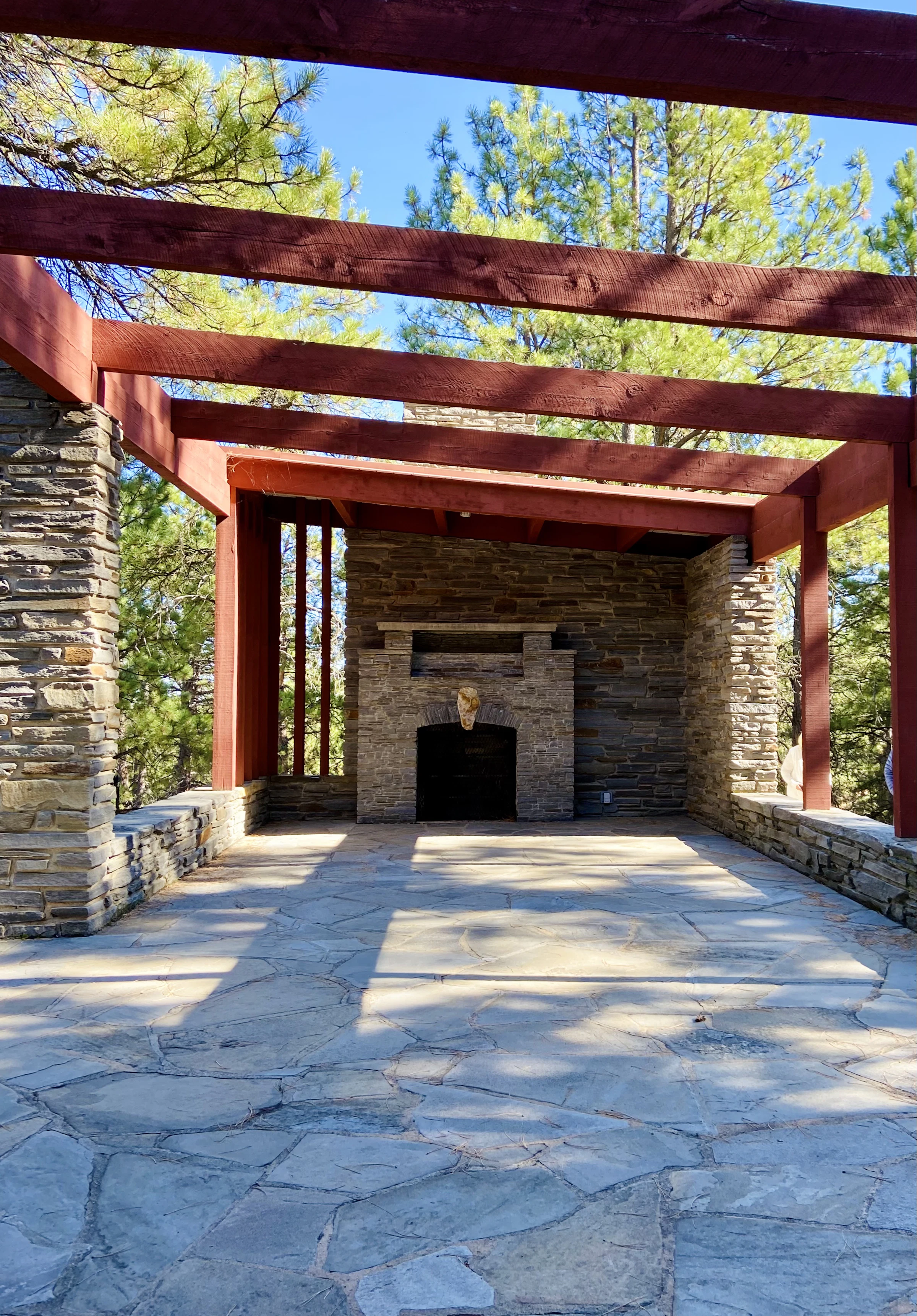 Finished stone patio with fireplace and pergola