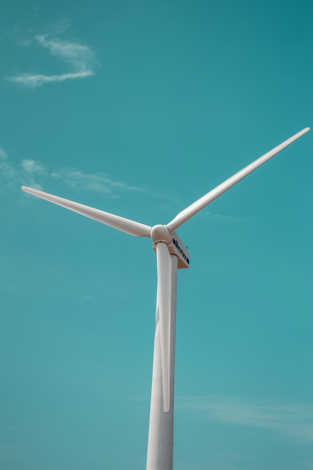 a wind turbine with a blue sky in the background