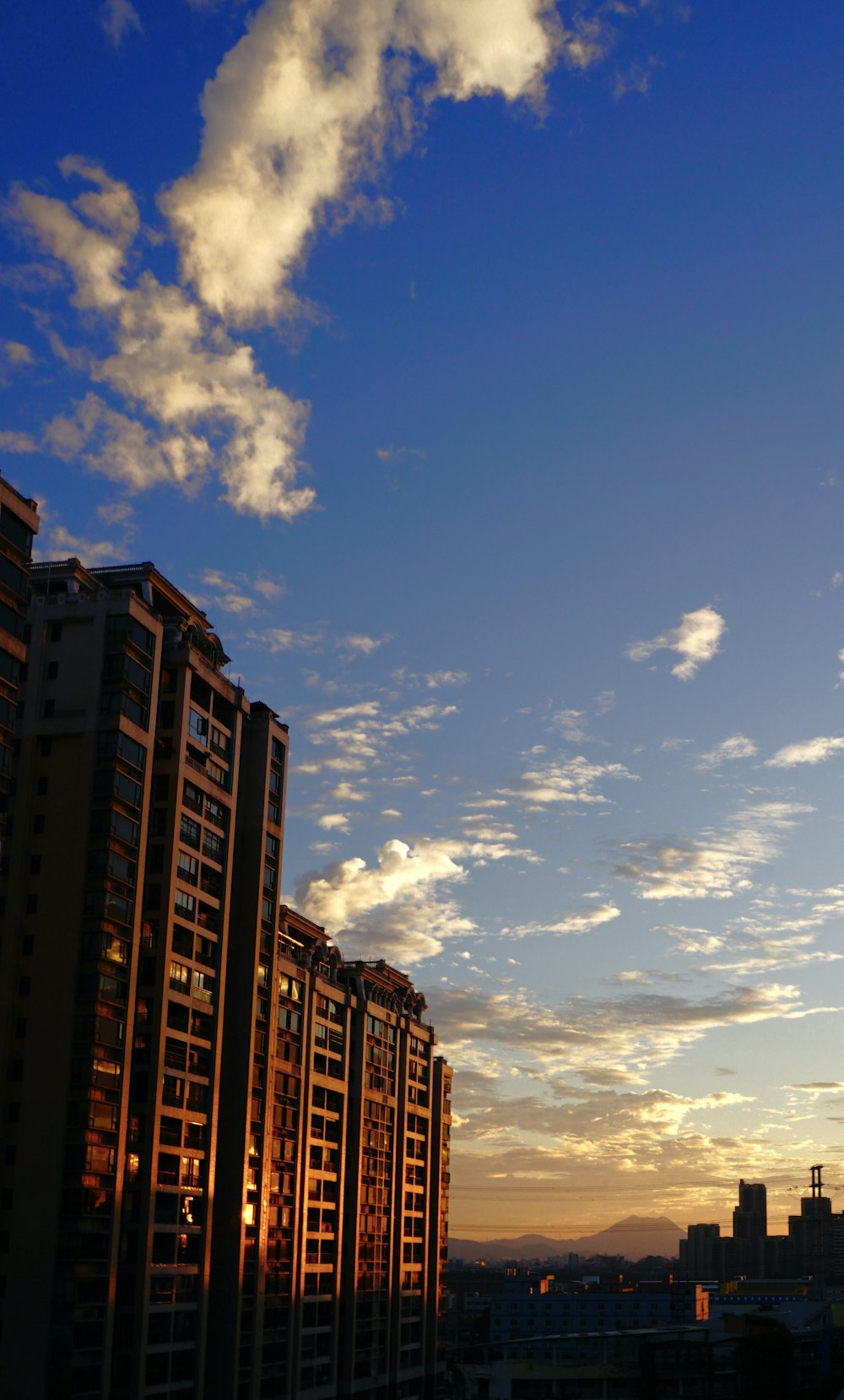 a very tall building with some clouds in the sky