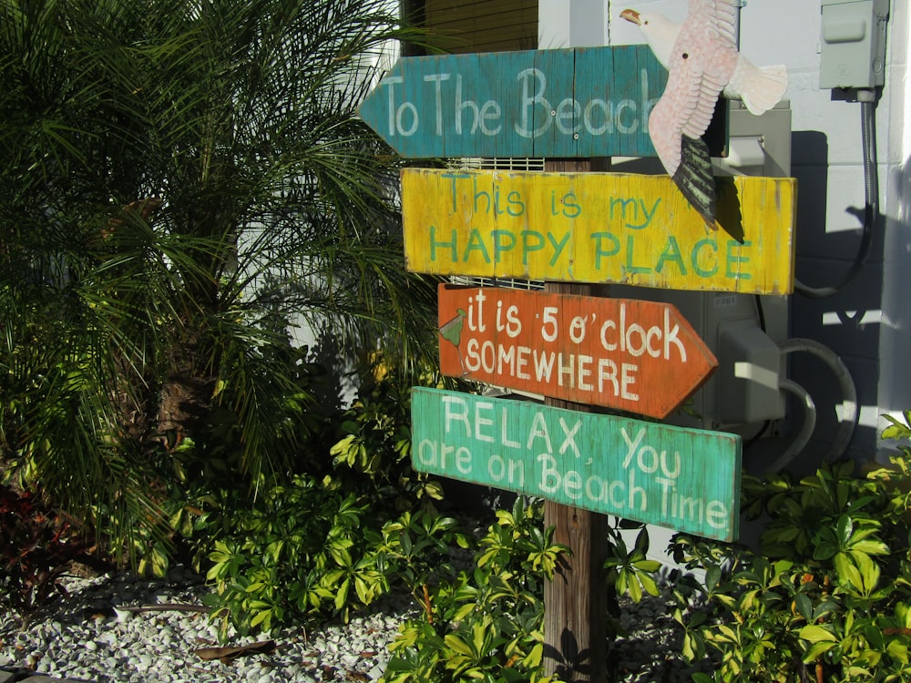 a wooden sign that says to the beach, what is my happy place, it