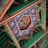 Intricate and colorful traditional ceiling decoration featuring detailed geometric patterns and ornate artwork. The design includes vibrant colors and symmetrical layouts, with a central motif that appears to depict a mythical scene.