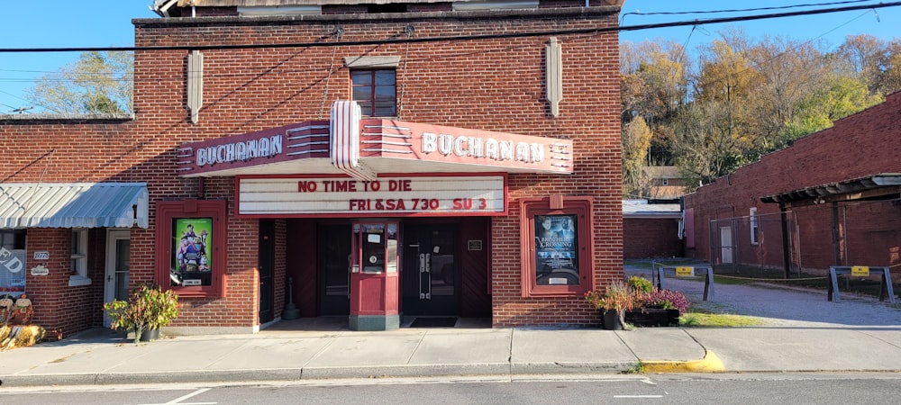 a brick building with a theater sign on the front of it