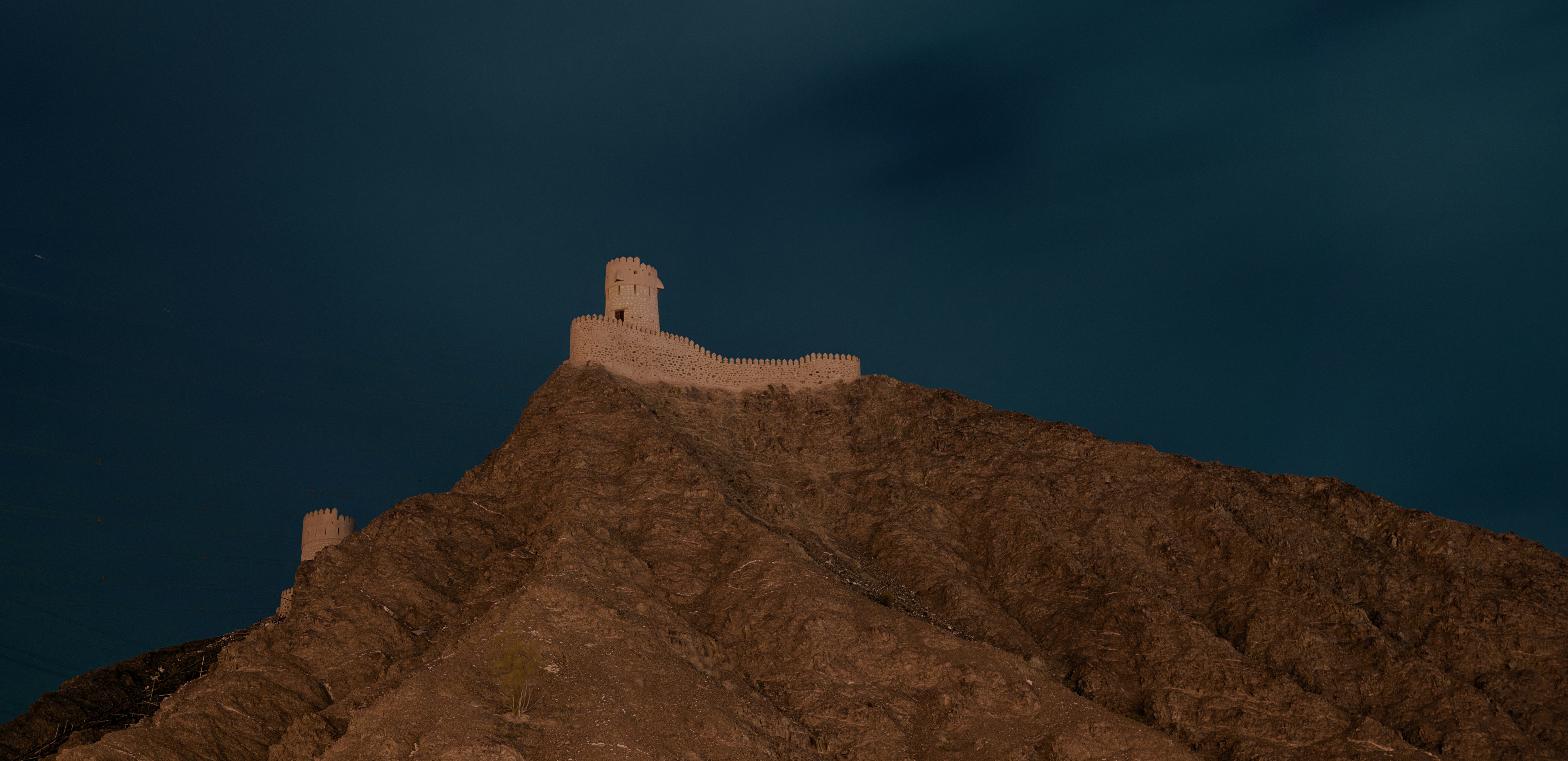 a castle on top of a mountain at night