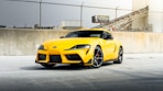 a yellow sports car parked in a parking lot