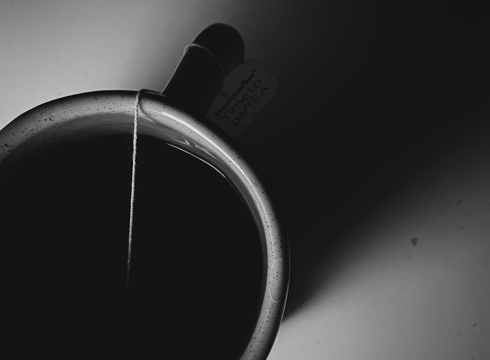 a black and white photo of a coffee cup