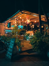 a restaurant with a lit up sign in front of it