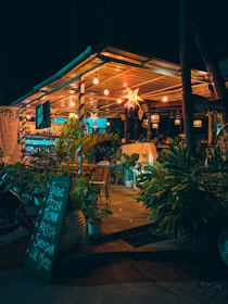 a restaurant with a lit up sign in front of it