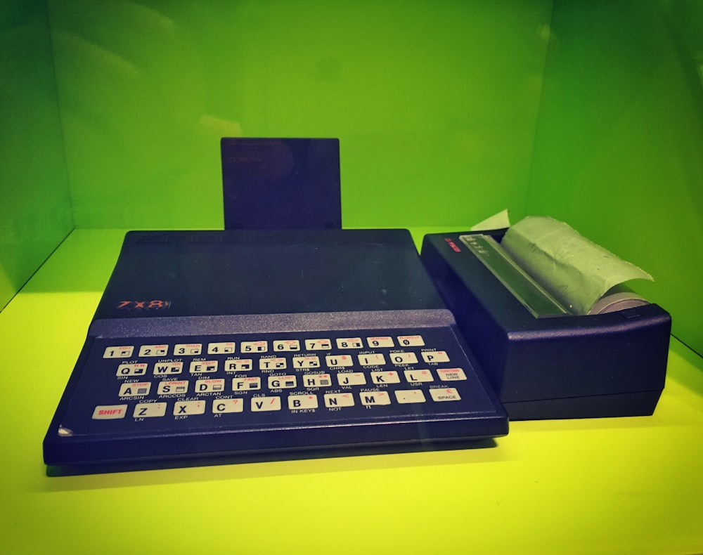 an old fashioned calculator sitting on top of a counter