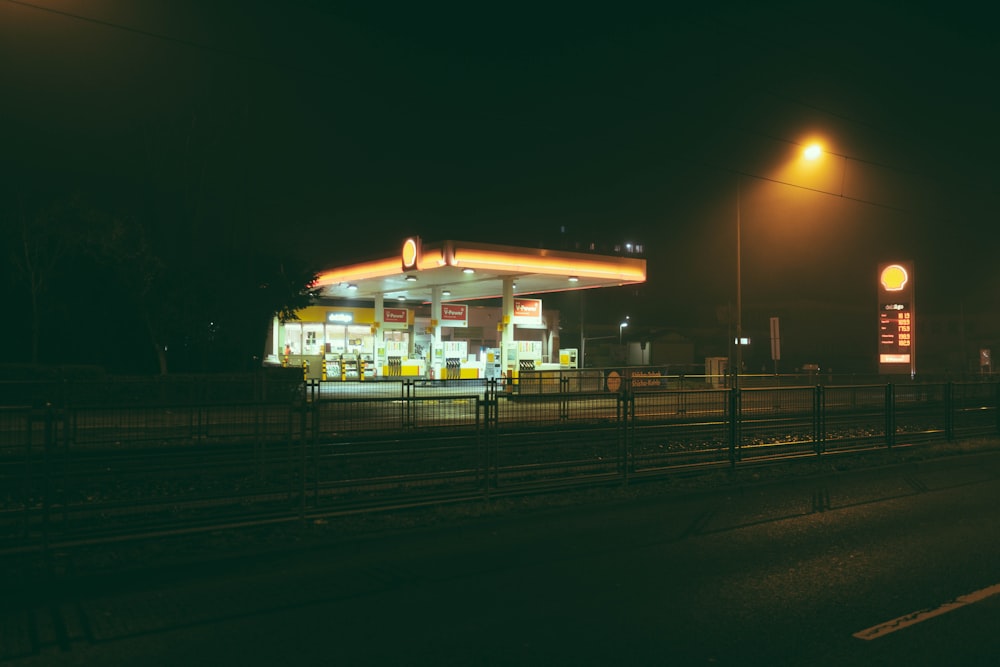 a gas station is lit up at night