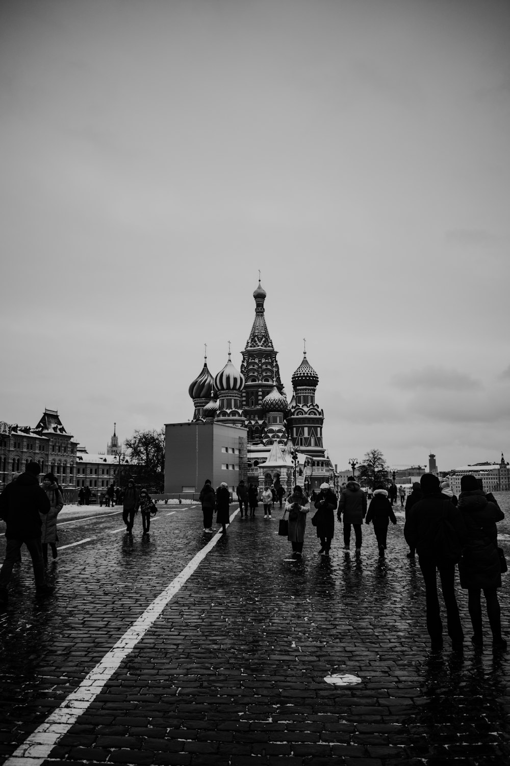 a black and white photo of people walking in the rain