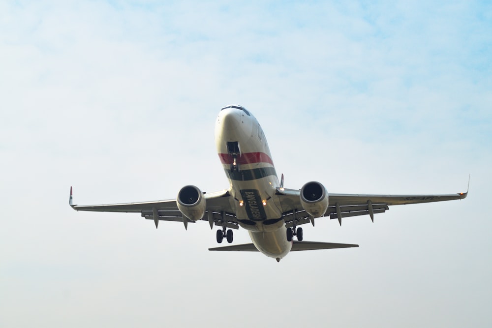 a large jetliner flying through a blue sky