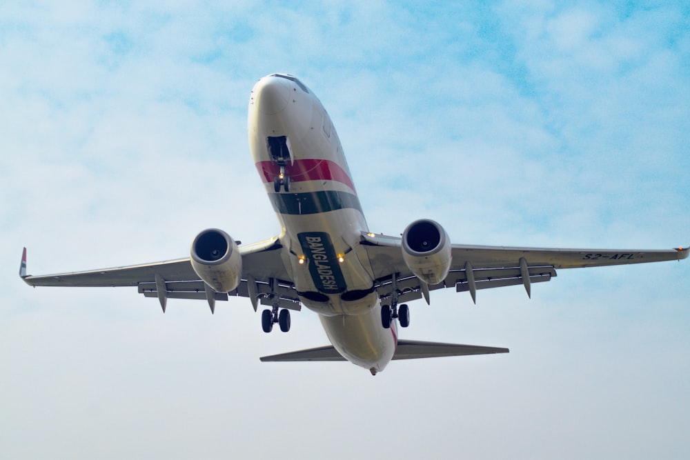 a large jetliner flying through a blue sky