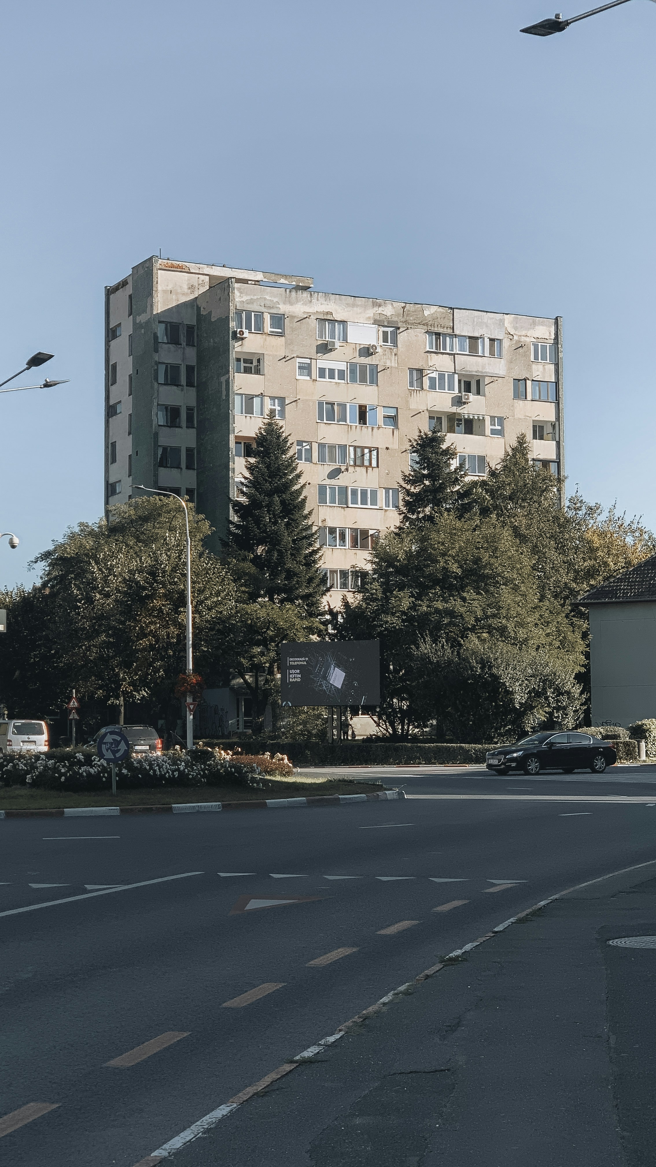 a very tall building sitting on the side of a road