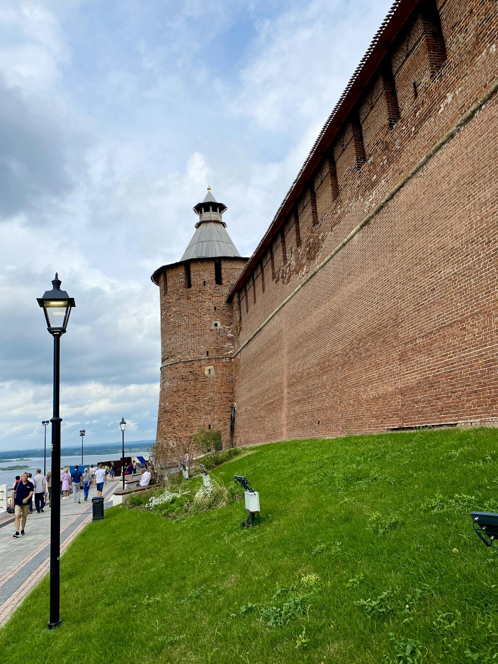 a large brick wall next to a street light