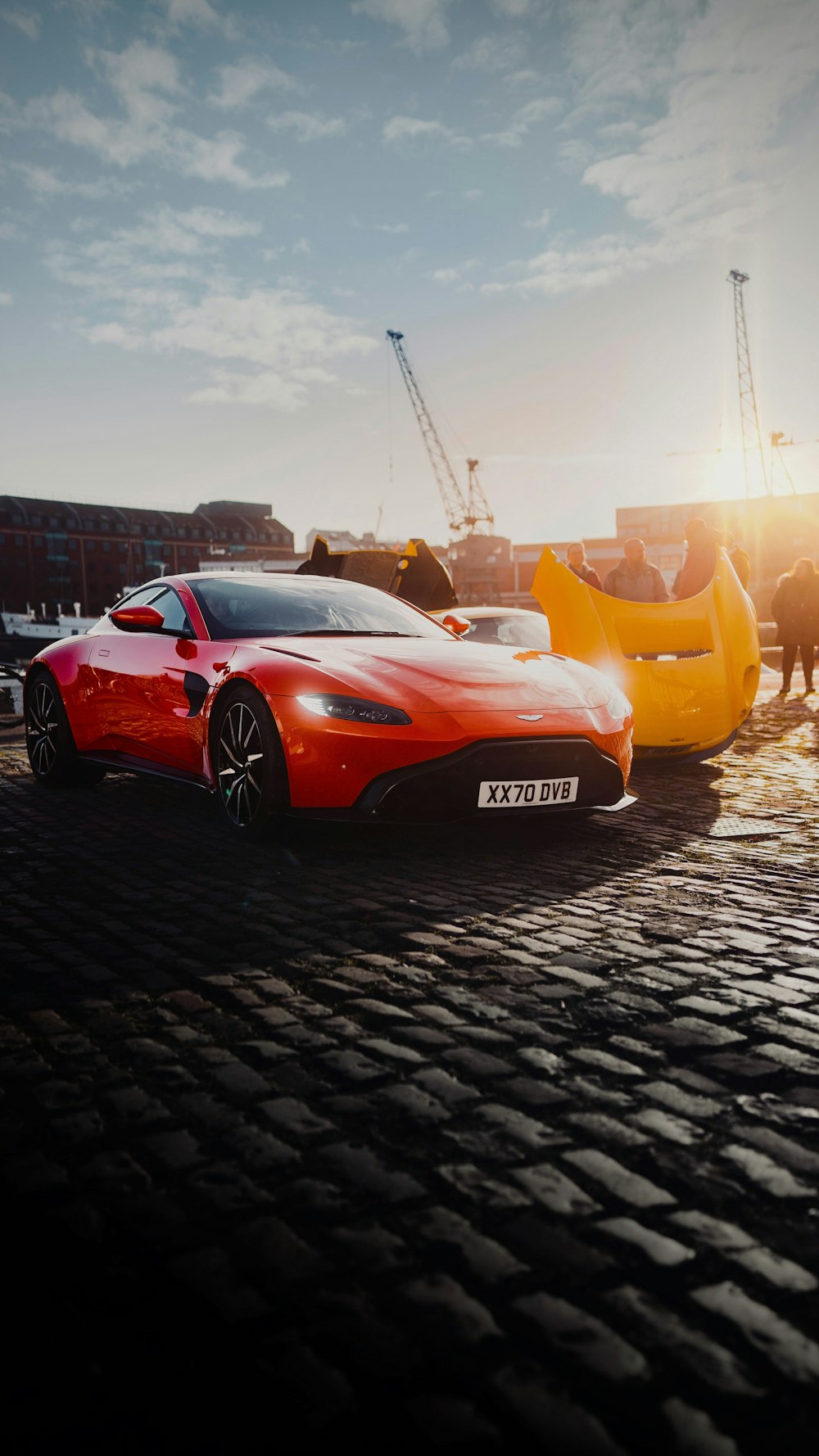 a red sports car parked next to a yellow sports car