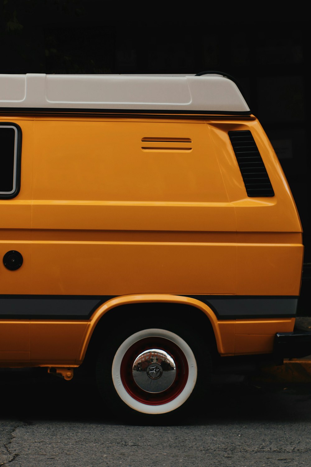 an orange van parked on the side of the road